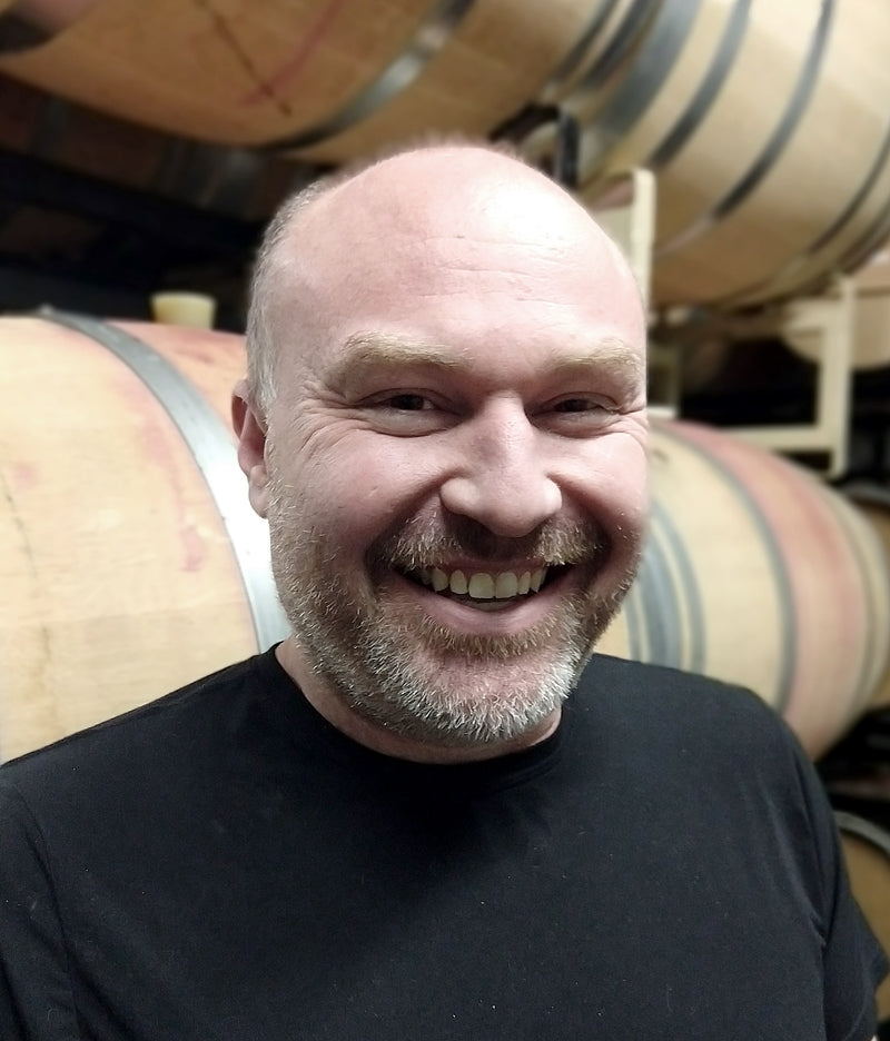 Jason Smith Winemaker Smiling Barrels 