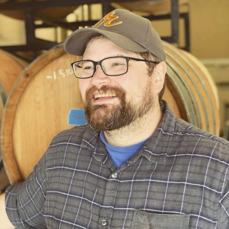Stan Tomson Assistant Winemaker Smiling Barrels